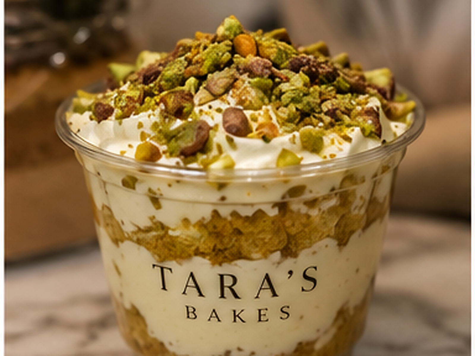 Pistachio milk cake in a Tara's Bakes cup